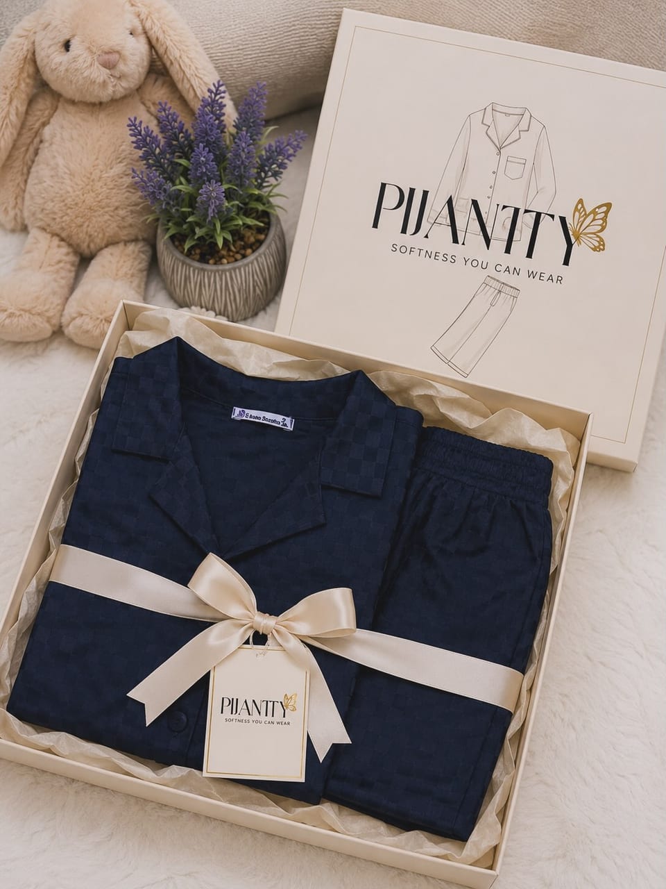 Navy Pijamty homewear arranged with a cream ribbon in a gift box